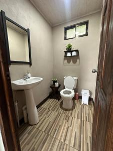 a bathroom with a sink and a toilet at Rancho and Modern Rustic House with a Valley View in Venecia +22 photos
