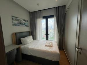 a bedroom with a bed and a window at RESidenza Condonium - D1mension & Zenity Tower, SG's Heart & Gym, Pool in Ho Chi Minh City +44 photos