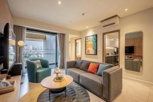 a living room with a couch and a table at RESidenza Condonium - D1mension & Zenity Tower, SG's Heart & Gym, Pool in Ho Chi Minh City