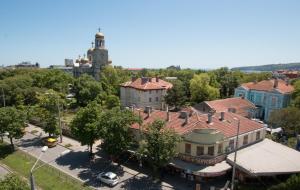 an aerial view of a town with a building and a tower at Hotel Divesta - self check in in Varna City