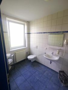 a bathroom with a sink and a toilet at Pilotenunterkunft Fliegerhorst in Strausberg +25 photos