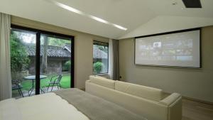 une chambre avec un lit et un écran de projection dans l'établissement Wuyi Zizai Valley Homestay, 