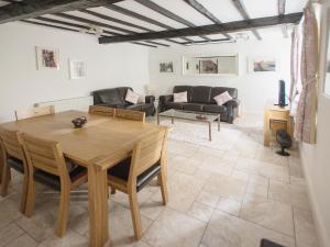 a living room with a table and a couch at Barbican Cottage in Middleham