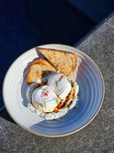 a plate of food with eggs and bread on it at Ayara Kamala Resort & Spa in Kamala Beach