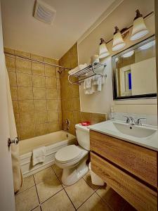 a bathroom with a toilet and a sink at Caravel Motel in Swift Current