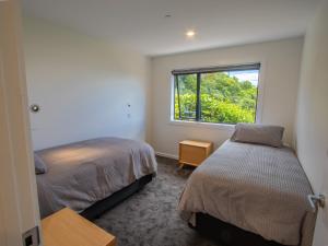 a bedroom with two beds and a window at Vista Serena in Pohara