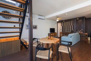 a living room with a loft bed and a table and chairs at Meadows in Uluwatu
