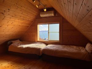 Voodi või voodid majutusasutuse 牛窓Lodge-海と木の温もりに包まれる癒しの空間 ペット同伴可 toas