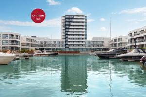a body of water with boats in front of buildings at GRANO HOTEL Solmarina in Wiślinka
