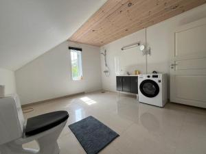 a large white room with a washing machine in it at Hvaler Apartment - Skjærhalden, Storesand in Hvaler