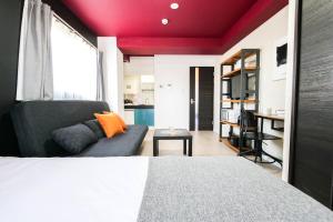 a bedroom with a bed and a couch at Mr Kintaro Hotel Asakusa South in Tokyo