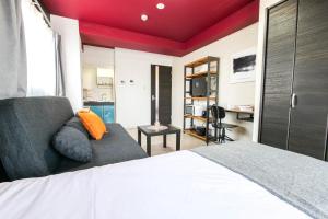 a bedroom with a bed and a couch at Mr Kintaro Hotel Asakusa South in Tokyo