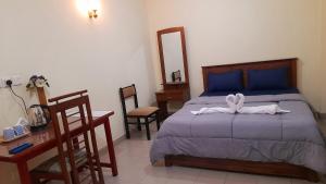 a bedroom with a bed with a bow on it at Madara Hotel in Horana +8 photos