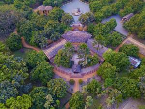 an overhead view of a mansion in the middle of trees at Unnati Cultural Village in Maruwā Ghāt