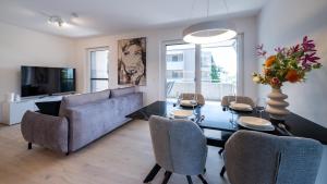 a living room with a table and chairs and a couch at Apartments Jesse in Sankt Kanzian
