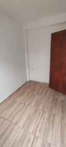 an empty room with a wooden floor and white walls at Cantinho Do Sossego in Nova Iguaçu