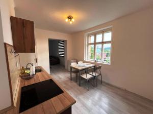 a kitchen with a table and a dining room at Apartmán u Koupaliště in Česká Kamenice