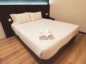 Postel nebo postele na pokoji v ubytování Emart Hotel (Riam)