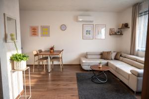 a living room with a couch and a table at Villa Dunaj 2 in Dunajská Streda