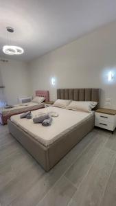 a bedroom with a large bed and a couch at Alessio Beach House in Durrës +17 photos