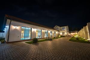 a large white building with lights on it at night at Luxury Beachfront Villa with Indoor Pool & BBQ in Baku
