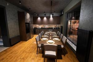 a dining room with a long table and chairs at Luxury Beachfront Villa with Indoor Pool & BBQ in Baku