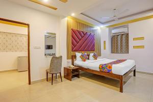 a hotel room with a bed and a chair at FabHotel 22 Squares Living Spaces - Nr Calangute Beach in Calangute +27 photos