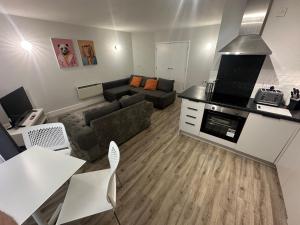 a small living room with a couch and a kitchen at City centre apartment 2 in Cardiff