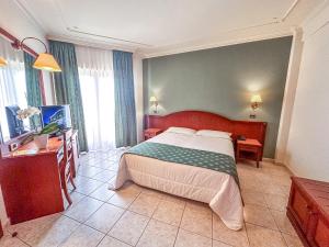 Postel nebo postele na pokoji v ubytování Hotel Valle Rossa