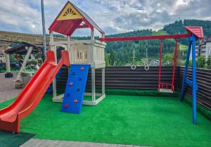 a playground with a slide and a slideintend at Mountain Krystal in Bukovel
