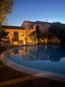 a large swimming pool in front of a house at Domus Lavinia in Badesi +34 photos
