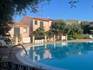 a swimming pool in front of a house at Domus Lavinia in Badesi