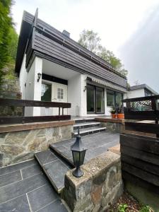 a house with a porch and a street light in front of it at Fagre Stryn Feriehus in Stryn