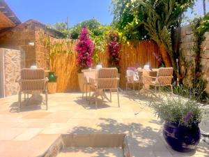 a patio with chairs and a fence with flowers at Casa Tua - Countryhouse- in Sorrento