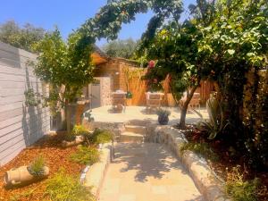 a garden with a patio and trees and a building at Casa Tua - Countryhouse- in Sorrento