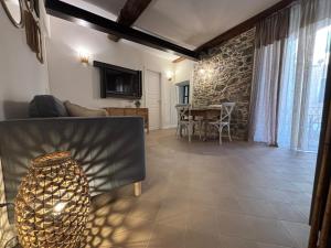 a living room with a couch and a table at HH Moneglia la Piazzetta in Moneglia