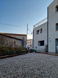 a courtyard of a building with two buildings at Les Ametlles in Masarach