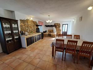 a kitchen and dining room with a table and chairs at Apartman Kornu in Veli Lošinj