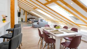 a dining room with a white table and chairs at Flowers Dubrovnik Luxury Apartments in Dubrovnik