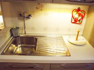 a kitchen counter with a sink in a kitchen at Blue House Termini-Colosseo in Rome +18 photos