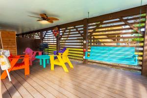 a room with colorful chairs and tables and a blue bench at 5010 - Home Sweet Helga in Avalon Bench