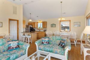 a living room with two couches and a kitchen at 1680 - Hopes and Dreams in Poplar Branch +37 photos