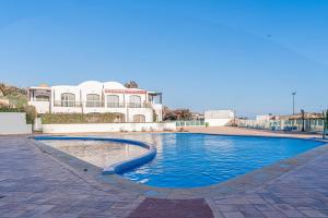 a large swimming pool in front of a building at Luxury Villa Ocean View with pool in Tiguert
