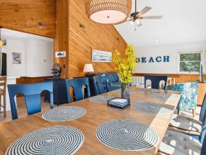 a dining room with a table and blue chairs at 3041 - The Beach House in Southern Shores