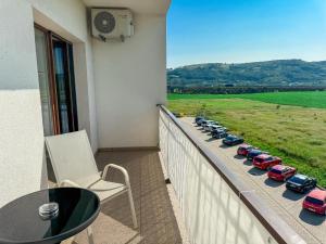 a balcony with a row of cars parked on a ledge at EMSI Apartment in Sebeş +6 photos
