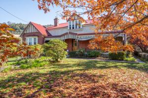 a house in the fall with leaves on the yard at Franklin Lodge, Huon Valley, Tasmania, Lavender Room in Franklin