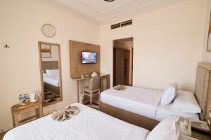 A bed or beds in a room at Teba Hotel Ras Elbar
