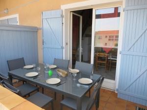 - une table avec des chaises et une table avec des assiettes dans l'établissement Les Flots Bleus Etage, à Biscarrosse-Plage