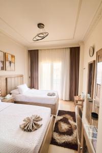 A bed or beds in a room at Teba Hotel Ras Elbar