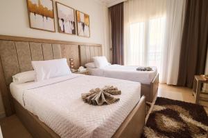 A bed or beds in a room at Teba Hotel Ras Elbar